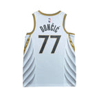 Urban Cult white NBA Dallas Mavericks 2019/2020 Luka Doncic 77 jersey with gold trim and blue numbers.