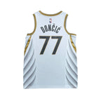 Urban Cult white NBA Dallas Mavericks 2019/2020 Luka Doncic 77 jersey with gold trim and blue numbers.