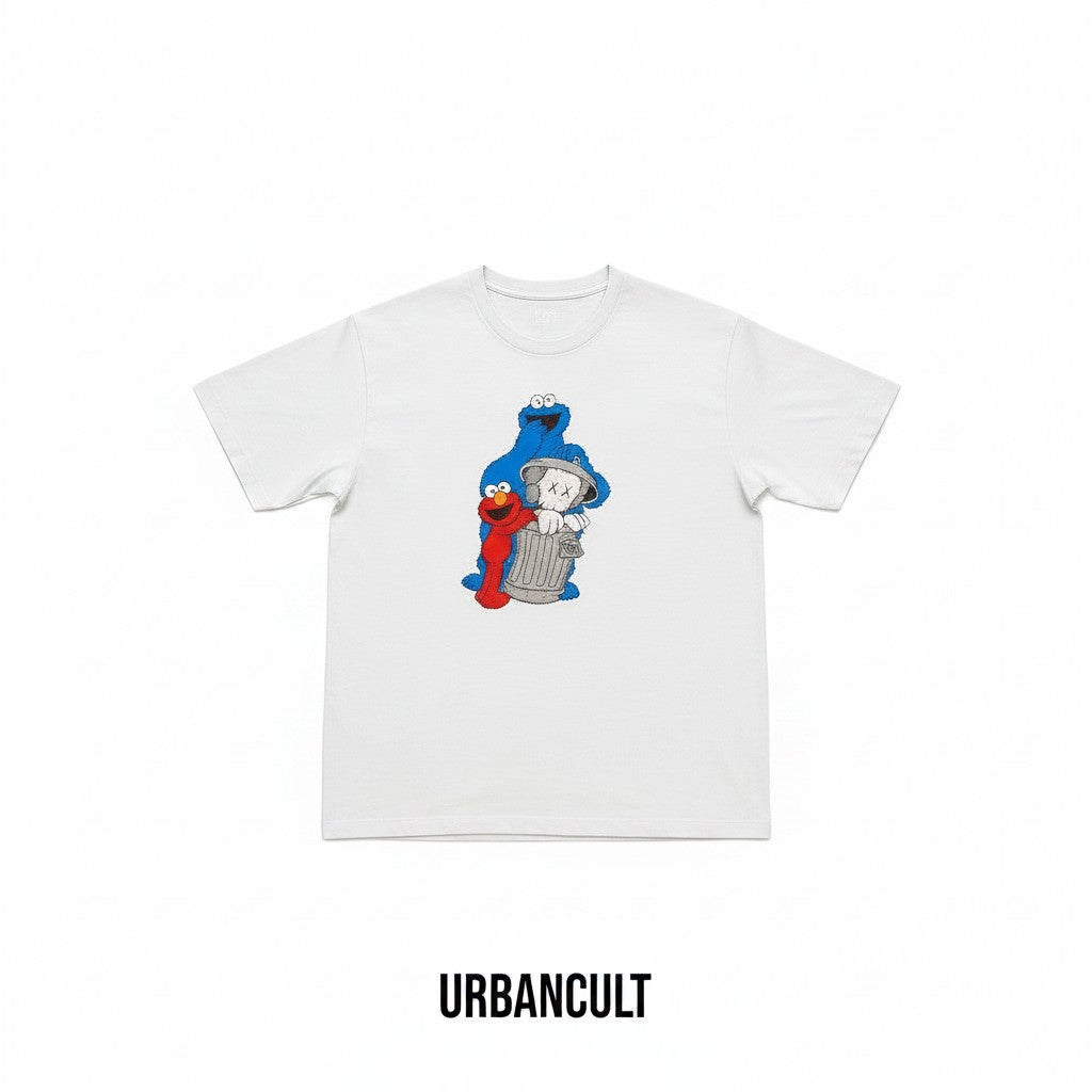 Urban Cult light blue cotton t-shirt with KAWS x Uniqlo x Sesame Street graphic featuring Companion, Elmo, Cookie Monster and Oscar's trash can.