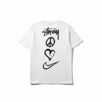 Urban Cult white cotton t-shirt with Nike x Stüssy 'Peace, Love, Swoosh' graphic print on back.