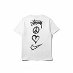 Urban Cult white cotton t-shirt with Nike x Stüssy 'Peace, Love, Swoosh' graphic print on back.